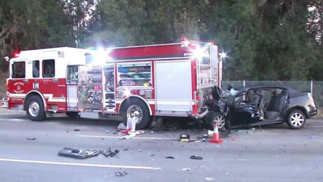 A Tesla sits crumpled against the back of a San Jose fire engine after a wreck on Saturday, Aug. 25, 2018.