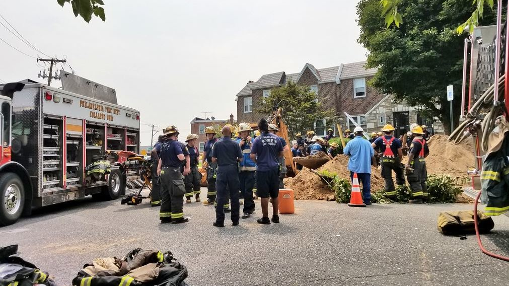 Philadelphia firefighters on scene during efforts to rescue a worker who was found dead after a trench collapse on Thursday, Aug. 16, 2018.