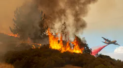 Fire retardant is dropped near a home as the Mendocino Complex Fire burns near Lakeport on July 30, 2018.