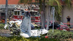 Orange County firefighters monitor the scene where five people were killed in a plane crash Sunday. Orange County firefighters monitor the scene where five people were killed in a plane crash Sunday.