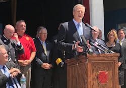 The Professional Fire Fighters of Massachusetts and Gov. Charlie Baker, pictured at lectern, worked on a bill to designate cancer as a work-related injury for state firefighters. The Professional Fire Fighters of Massachusetts and Gov. Charlie Baker, pictured at lectern, worked on a bill to designate cancer as a work-related injury for state firefighters.