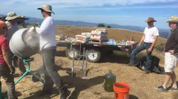 A construction crew works on installation of a tower in Sonoma County, CA, that will house a high-definition camera as part of a wide network designed to monitor wildfire activity.