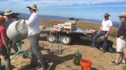 A construction crew works on installation of a tower in Sonoma County, CA, that will house a high-definition camera as part of a wide network designed to monitor wildfire activity. A construction crew works on installation of a tower in Sonoma County, CA, that will house a high-definition camera as part of a wide network designed to monitor wildfire activity.