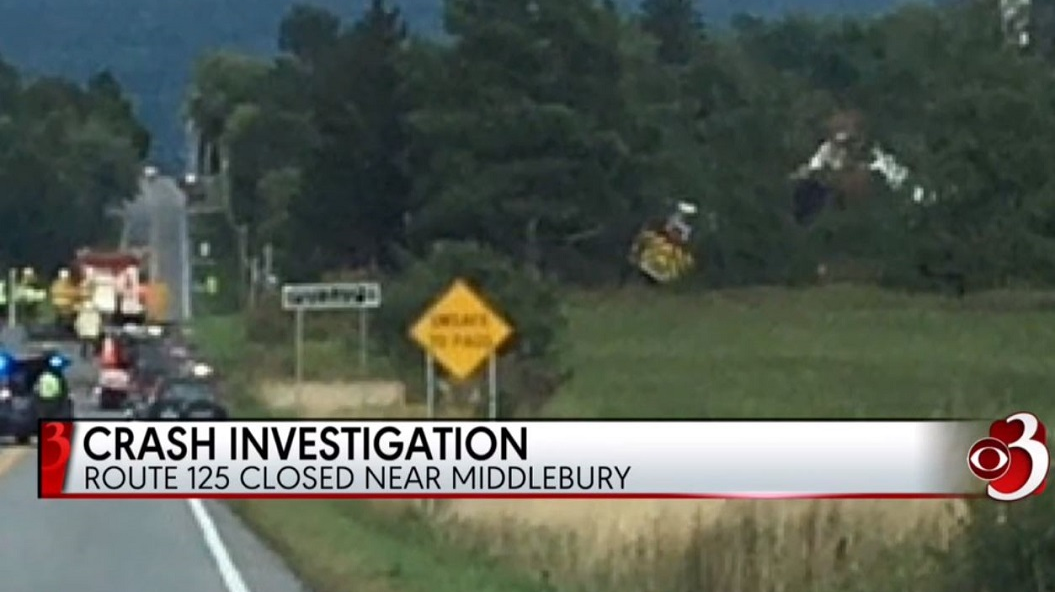 A Cornwall, VT, fire apparatus can be seen in a wooded area beside a roadway after a wreck that left a pickup driver dead and a firefighter injured on Sunday, Sept. 9, 2018.