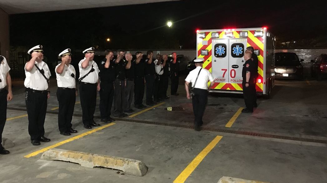 Chicago firefighters salute as an ambulance brings the body of Capt. Darryl Moore to the Cooke County Medical Examiner's Office on Monday, Sept. 17, 2018.