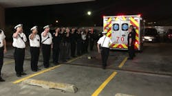 Chicago firefighters salute as an ambulance brings the body of Capt. Darryl Moore to the Cooke County Medical Examiner&apos;s Office on Monday, Sept. 17, 2018.