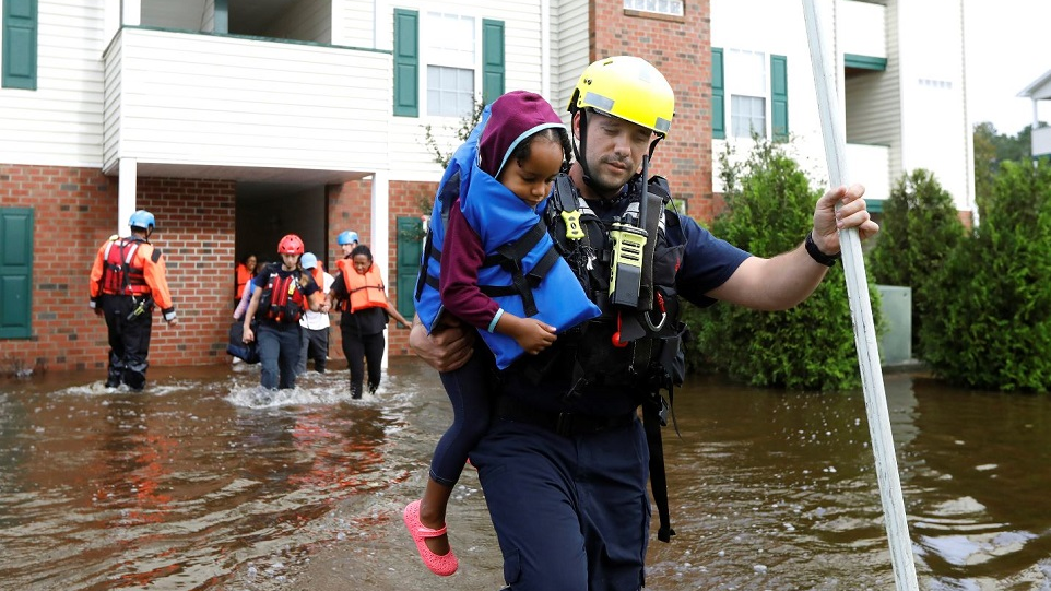 Capt. Steven Barker with the Spring Lake Fire Department helps evacuate residents from the Heritage at Fort Bragg Apartments in Spring Lake, N.C. on Monday, Sept. 17, 2018.