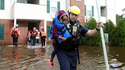 Capt. Steven Barker with the Spring Lake Fire Department helps evacuate residents from the Heritage at Fort Bragg Apartments in Spring Lake, N.C. on Monday, Sept. 17, 2018.