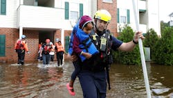 Capt. Steven Barker with the Spring Lake Fire Department helps evacuate residents from the Heritage at Fort Bragg Apartments in Spring Lake, N.C. on Monday, Sept. 17, 2018.
