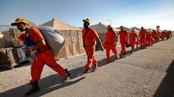 Inmates with the California Department of Corrections and Rehabilitation (CDCR) work on a fire crew during the Thomas Fire in Ventura, CA, on Dec. 12, 2017.