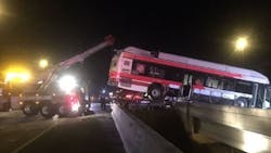 A bus can be seen dangling over a median gap on Interstate 95 after a wreck on Sunday, Sept. 9, 2018, in Jacksonville, FL.