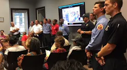 Moss Point, MS, firefighters attend a board meeting on Tuesday, Sept. 18, 2018, where they presented a petition of protest on a proposed restructuring of the city's fire department.