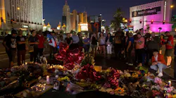 A crowd gathers along Las Vegas Boulevard on Oct. 4, 2017, to pay tribute at a memorial for the 58 victims killed in a mass shooting at a music festival three days earlier.