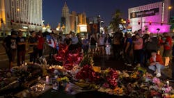 A crowd gathers along Las Vegas Boulevard on Oct. 4, 2017, to pay tribute at a memorial for the 58 victims killed in a mass shooting at a music festival three days earlier.