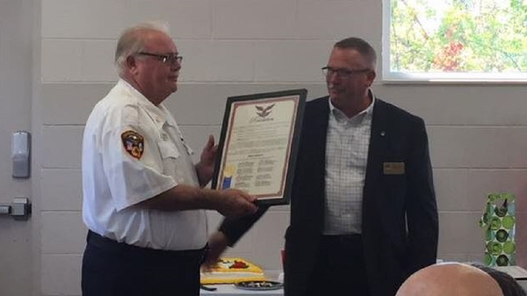 Davison-Richfield Fire Chief Mike Wright, left, is presented with a plaque commemorating his 46 years in fire service during a retirement announcement on Sept. 17, 2018.