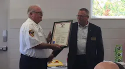 Davison-Richfield Fire Chief Mike Wright, left, is presented with a plaque commemorating his 46 years in fire service during a retirement announcement on Sept. 17, 2018.