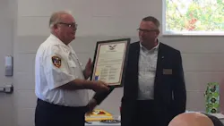 Davison-Richfield Fire Chief Mike Wright, left, is presented with a plaque commemorating his 46 years in fire service during a retirement announcement on Sept. 17, 2018.