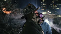 Rescue 5 firefighter Joey Esposito wears a breathing mask during recovery efforts at the World Trade Center in Lower Manhattan in December 2001.