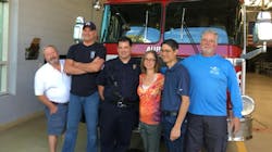 Lisa Yee, second from right, poses with her husband Ted and four of the Aurora firefighters who rescued her after a serious car wreck left her with traumatic injuries in September 2008.