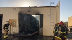 Firefighters on scene after a two-alarm fire at an auto body shop in Westminster, CA, on Thursday, Oct. 11, 2018.