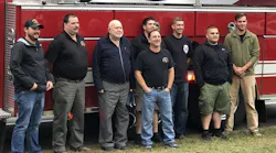 Eugene Carroll, third from left, poses with his fellow Morrisonville firefighters as they gather to celebrate his 90th birthday on Sunday, Oct. 7, 2018.