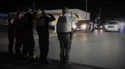 Gulf County first responders salute as a procession passes transporting the body of firefighter/paramedic Brad Price after he was killed while clearing debris in the wake of Hurricane Michael on Thursday, Oct. 18, 2018.