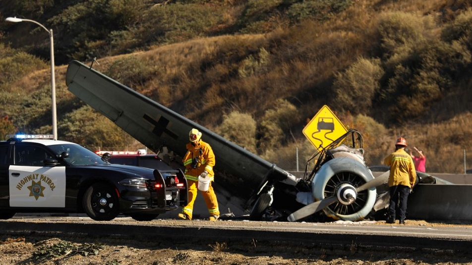 Los Angeles County firefighters on scene after a vintage World War II-era plane crashed on the 101 Freeway in Agoura Hills, CA, on Tuesday, Oct. 23, 2018.