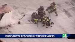 Sacramento firefighters pull a colleague to safety after he began to fall through the roof of a commercial building during a fire on Wednesday, Oct. 24, 2018. Sacramento firefighters pull a colleague to safety after he began to fall through the roof of a commercial building during a fire on Wednesday, Oct. 24, 2018.