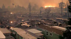 The Tubbs Fire burns in the background after leveling an entire neighborhood in Santa Rosa, CA, in October 2017.