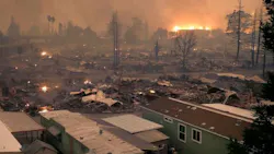 The Tubbs Fire burns in the background after leveling an entire neighborhood in Santa Rosa, CA, in October 2017.