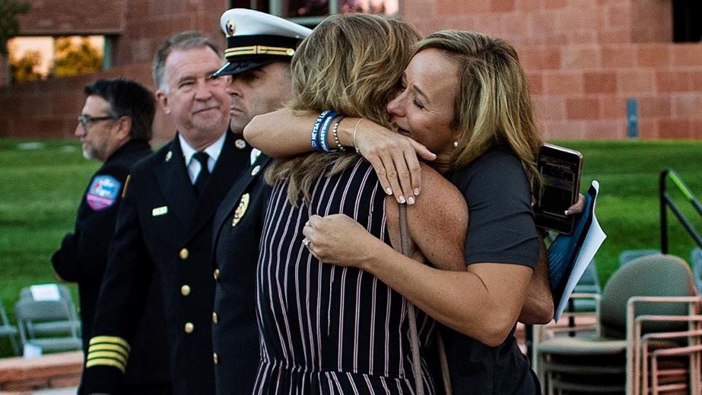 Mynda Smith, right, hugs Mary Jo Von Tillow after a sunrise remembrance to mark the one year anniversary of the Las Vegas mass shooting at the Clark County Government Center amphitheater on Monday, Oct. 1, 2018, in Las Vegas. Smith's sister Neysa Tonks and Von Tillow's husband Kurt Von Tillow were killed in the shooting.
