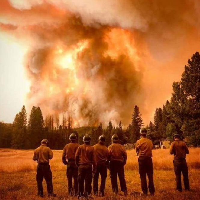 Firefighters look on as the Ferguson Fire rages near Yosemite National Park in Mariposa County, CA, in July 2018.