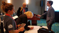 Joel M. Billing, Ph.D. Candidate at Oklahoma State University, right, talks to Firehouse Expo attendees after his presentation.