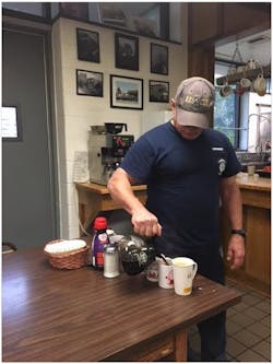 Lemoyne pouring coffee for everyone. He knows everyone’s cup down to what they take in their coffee. Lemoyne pouring coffee for everyone. He knows everyone’s cup down to what they take in their coffee.
