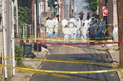 Officials gather at the scene of the explosion that left three dead.