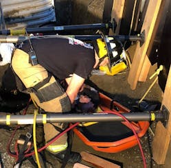 A Billings firefighter places the victim of a trench collapse into a bucket for transport during a rescue on Monday, Oct. 29, 2018.