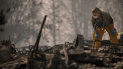 A search and rescue team member inspects an area for possible human remains in Paradise, CA, on Friday, Nov. 16, 2018. A search and rescue team member inspects an area for possible human remains in Paradise, CA, on Friday, Nov. 16, 2018.