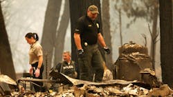 Authorities search for victims on Monday, Nov. 12, 2018, after the wind-driven Camp Fire swept through Paradise, CA.