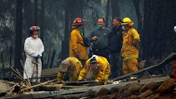 A forensic team investigates the site of a home where human remains were found on Nov. 13, 2018, after the Camp fire swept through Paradise, CA.