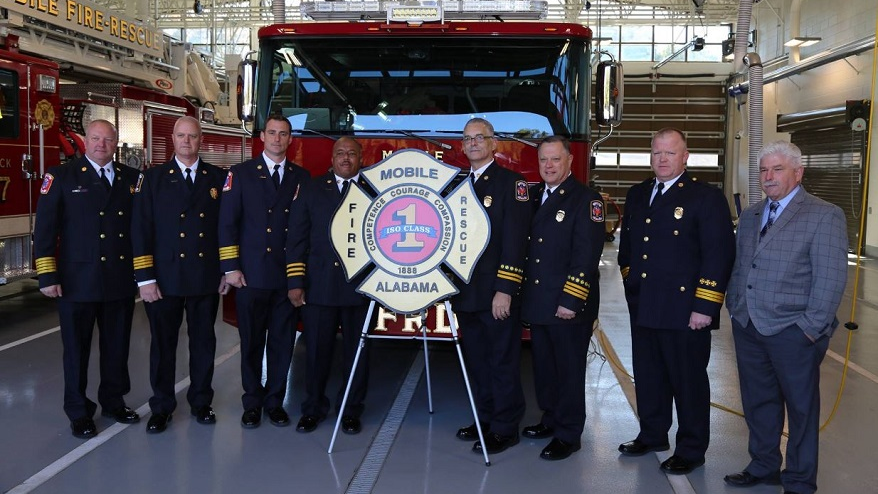 Mobile, AL, fire officials pose for a photo on Tuesday, Nov. 27, 2018, after announcing that the city's Fire-Rescue department has achieved a Class 1 rating from the ISO.