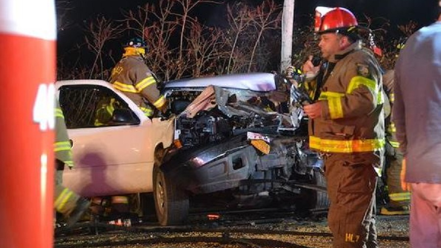 A pickup truck sits mangled after a firefighter was seriously injured in a crash while responding to a call in Murray, NY, on Monday, Nov. 12, 2018.