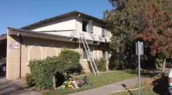 A ladder remains propped up against an apartment building after firefighters rescued two people who became trapped when a fire broke out in an adjacent unit on Wednesday, Nov, 7, 2018.