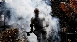 Battalion 13 Capt. Victor Correa with the Los Angeles County Fire Department helps put out hot spots on the Woolsey Fire in Malibu, CA, on Nov. 12, 2018.