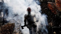 Battalion 13 Capt. Victor Correa with the Los Angeles County Fire Department helps put out hot spots on the Woolsey Fire in Malibu, CA, on Nov. 12, 2018. Battalion 13 Capt. Victor Correa with the Los Angeles County Fire Department helps put out hot spots on the Woolsey Fire in Malibu, CA, on Nov. 12, 2018.