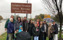The family of fallen Hamilton, OH, firefighter Patrick Wolterman poses in front of a sign dedicating a stretch of Route 4 in his honor on Thursday, Nov. 1, 2018. The family of fallen Hamilton, OH, firefighter Patrick Wolterman poses in front of a sign dedicating a stretch of Route 4 in his honor on Thursday, Nov. 1, 2018.