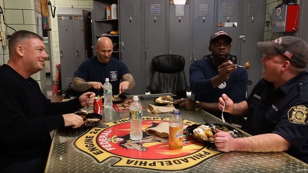Firefighters at South Philadelphia's Engine 24 firehouse enjoy mealtime together.