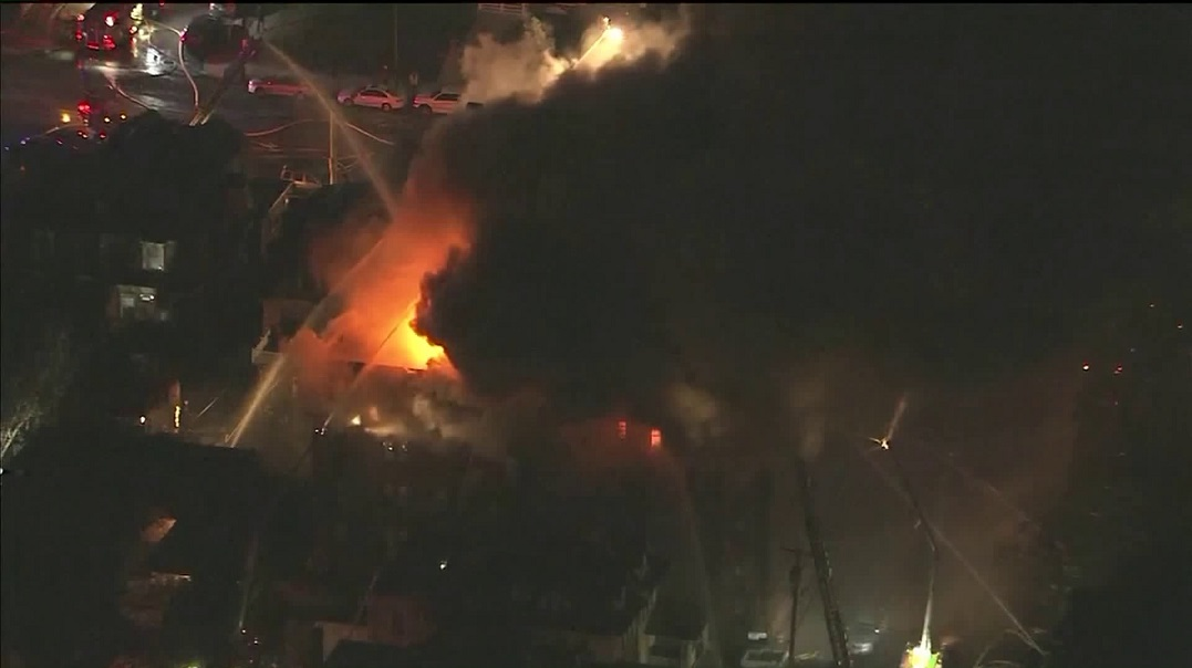 Two Philadelphia firefighters were hurt battling a five-alarm apartment fire early Monday. More than 100 firefighters responded to the blaze.