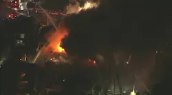 Two Philadelphia firefighters were hurt battling a five-alarm apartment fire early Monday. More than 100 firefighters responded to the blaze.