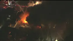 Two Philadelphia firefighters were hurt battling a five-alarm apartment fire early Monday. More than 100 firefighters responded to the blaze.