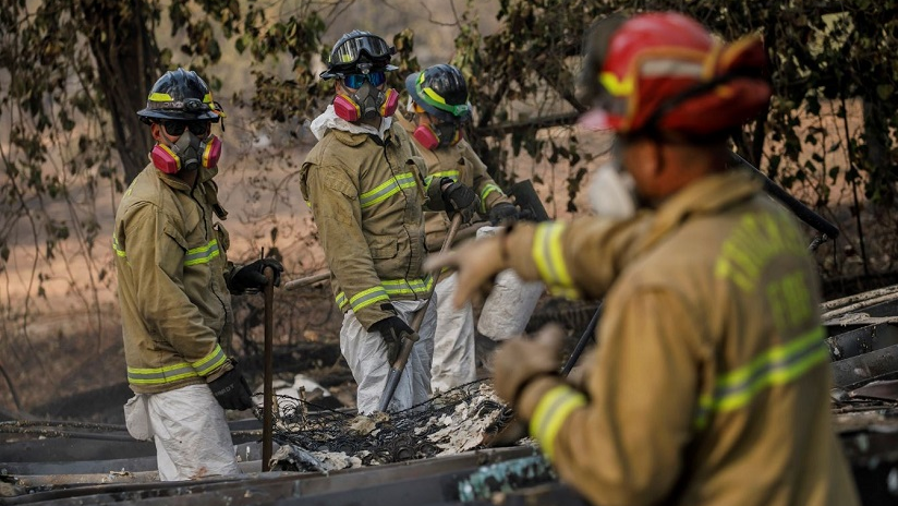 A search and rescue team combs through debris for human remains after the Camp Fire in Paradise, CA, on Nov. 20, 2018.